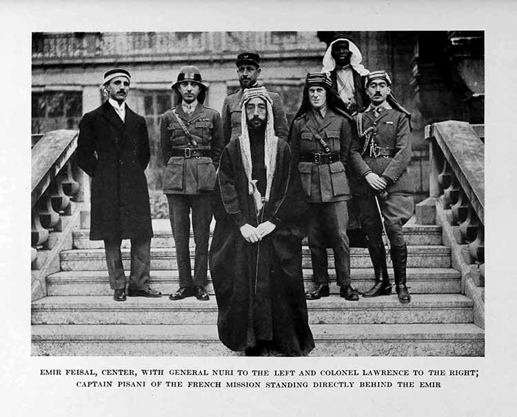 Photograph: EMIR FEISAL, CENTER, WITH GENERAL NURI TO THE LEFT     AND COLONEL LAWRENCE TO THE RIGHT, CAPTAIN PISANI OF THE FRENCH     MISSION STANDING DIRECTLY BEHIND THE EMIR