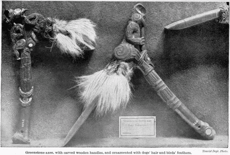 Tourist Dept. Photo.  Greenstone axes, with carved wooden handles, and ornamented with dogs' hair and birds' feathers.