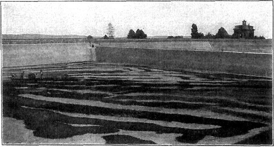 SCRAPING THE SEDIMENT FROM THE BOTTOM OF A RESERVOIR