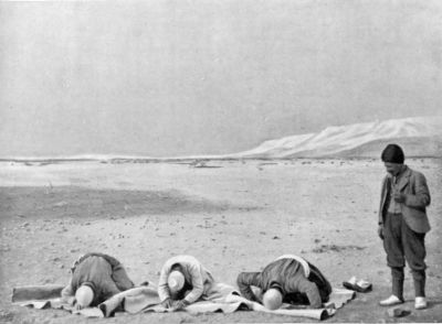 Camel Men saying their Prayers at Sunset.