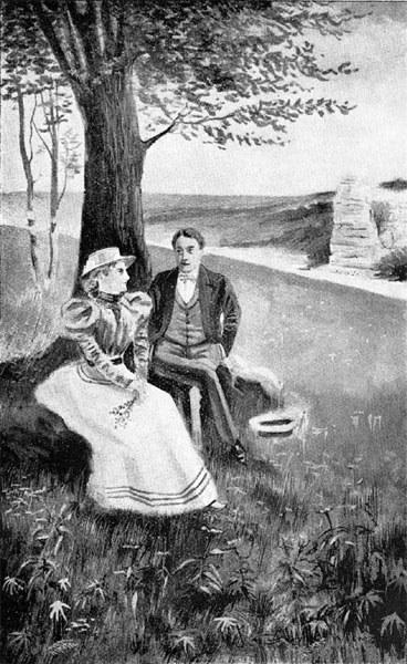 couple sitting under tree