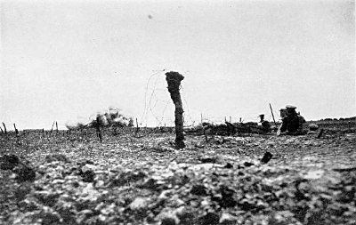 IN A SHELL HOLE IN "NO MAN'S LAND" FILMING OUR HEAVY BOMBARDMENT OF THE GERMAN LINES. I GOT INTO THIS POSITION DURING THE NIGHT PREVIOUS. IT WAS HERE THAT I EARNED THE SOUBRIQUET "MALINS OF NO MAN'S LAND"