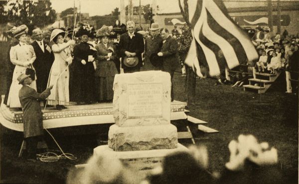 Unveiling of Monument at Kearney, Nebraska, in commemoration of the Oregon Trail  Left to right: Mrs. Ashton C. Shallenberger, Governor Shallenberger, Mrs. Oreal S. Ward, State Regent Nebraska Society, Daughters of the American Revolution; Mrs. Andrew K. Gault, Vice-President General, National Society, Daughters of the American Revolution; Mrs. Charles O. Norton, Regent Ft. Kearney Chapter, Daughters of the American Revolution; John W. Patterson, Mayor of Kearney; John Lee Webster, President Nebraska State Historical Society; Rev. R. P. Hammons, E. B. Finch, assisting with the flag rope