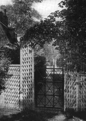 AN OLD-FASHIONED GARDEN IS OFTEN ENTERED UNDER AN ARCH OF LATTICEWORK