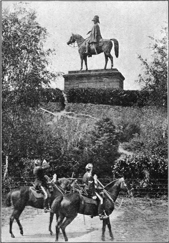 SOLDIERS SALUTING THE DUKE'S STATUE, AS IT STANDS AT ALDERSHOT TO-DAY.  From a Photo. By Knight, Aldershot.