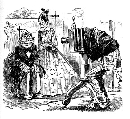 Under Her Breath.—Mrs. Conlan: "Whisht, Pat!"  Pat: "Whisht, Dalia!"  Mrs. Conlan: "Aise yure face. It's an upright we're havin' took."  From the New York "Judge."  SELECTED BY MR. RAVEN-HILL.