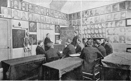 DETECTIVES RECEIVING A LECTURE ON THE METHOD OF IDENTIFICATION BY NOSES.  From a Photo.