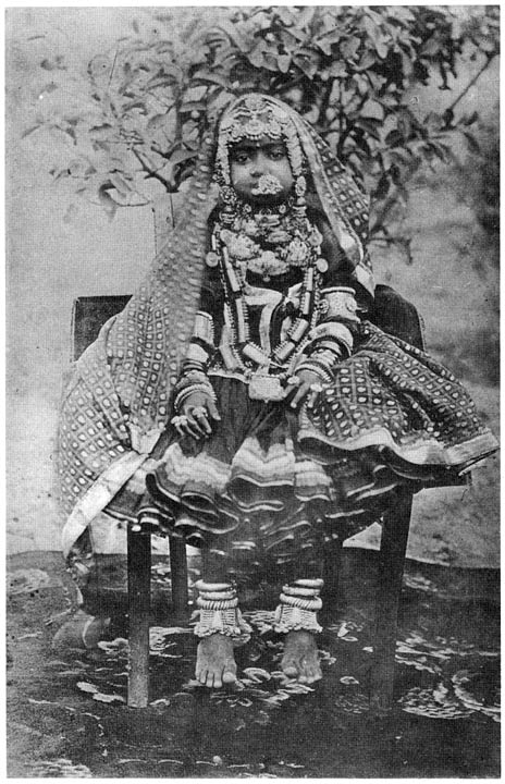 Girl in full dress and ornaments