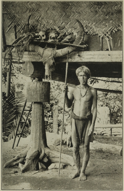 IGOROT OUTSIDE HIS HOUSE.