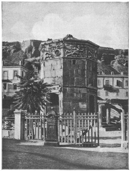 An octagonal tower with panels depicting the winds at the top