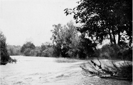 The Little Miami River at Eureka Mills, twelve miles east of Dayton. Here the ruin of the dam, which served the mills run by Mr. Howells’s father, makes a rapid in the stream.