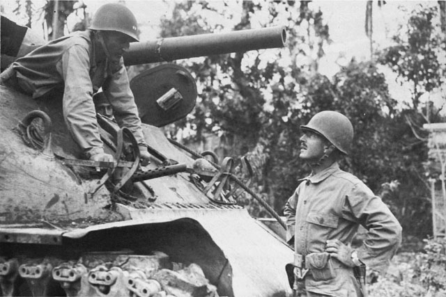 MAJ. GEN. VERNE D. MUDGE (in tank) confers with Brig. Gen. William C. Chase in Tacloban.