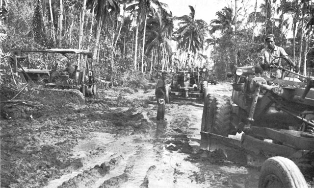 ACCESS ROAD FROM WHITE BEACH under repair (above). Filipino road workers on Route 2 (below).