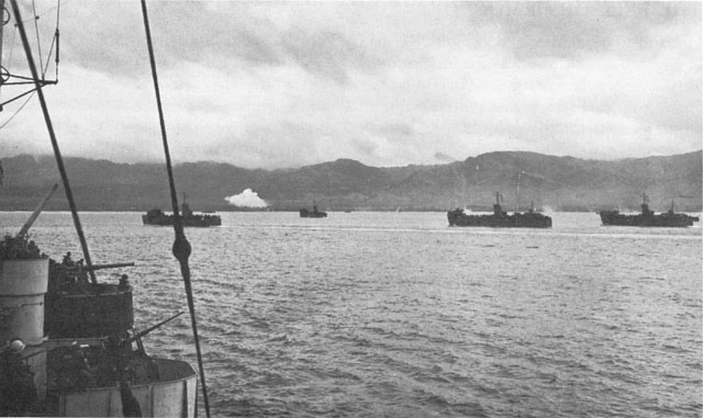 CONVOY CARRYING 77TH DIVISION APPROACHES DEPOSITO (above). Bombardment of enemy positions at Ipil (below), with stack of sugar mill visible. Village is near center of picture.