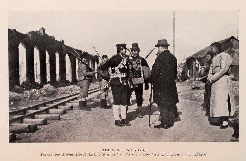 THE SING SENG ROAD. The smartest thoroughfare of Hankow, after the fire. For over a week fierce fighting was maintained here.