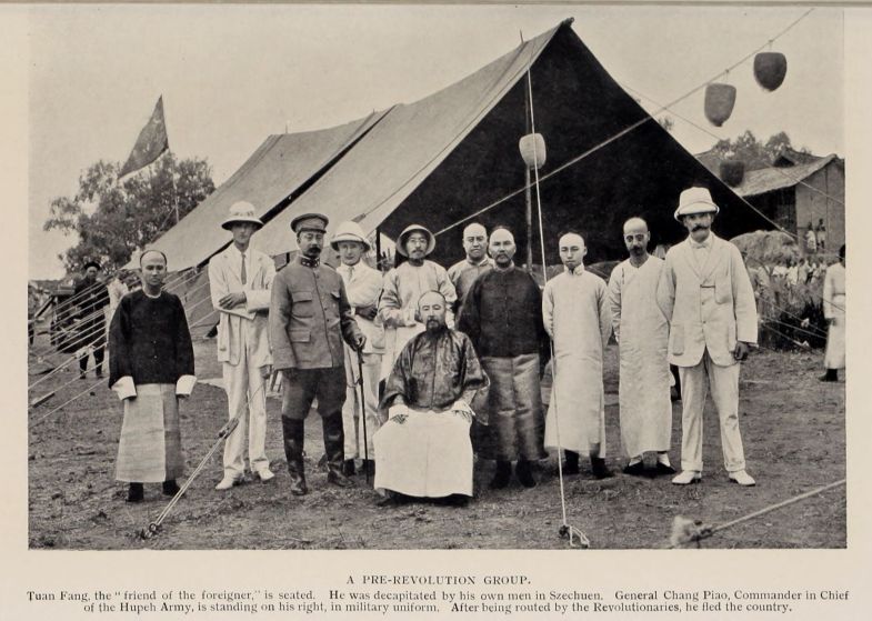 A PRE-REVOLUTION GROUP. Tuan Fang, the "friend of the foreigner," is seated. He was decapitated by his own men in Szechuen. General Chang Piao, Commander in Chief of the Hupeh Army, is standing on his right, in military uniform. After being routed by the Revolutionaries, he fled the country.