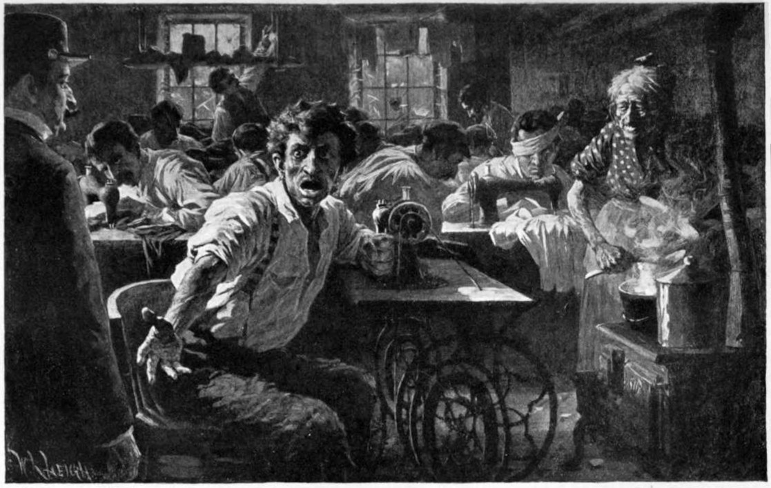 Many people in a room working at sewing machines. One man in the foreground is talking and appears angry.