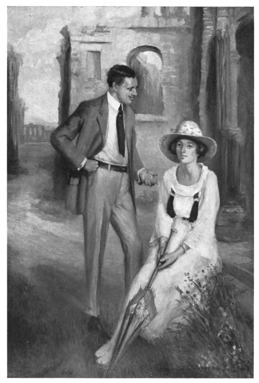 A man standing and a a seated woman