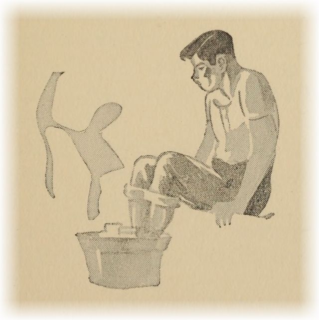 boy sitting with feet in a tub