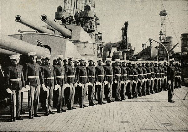 many Marines standing at attendion by battleship